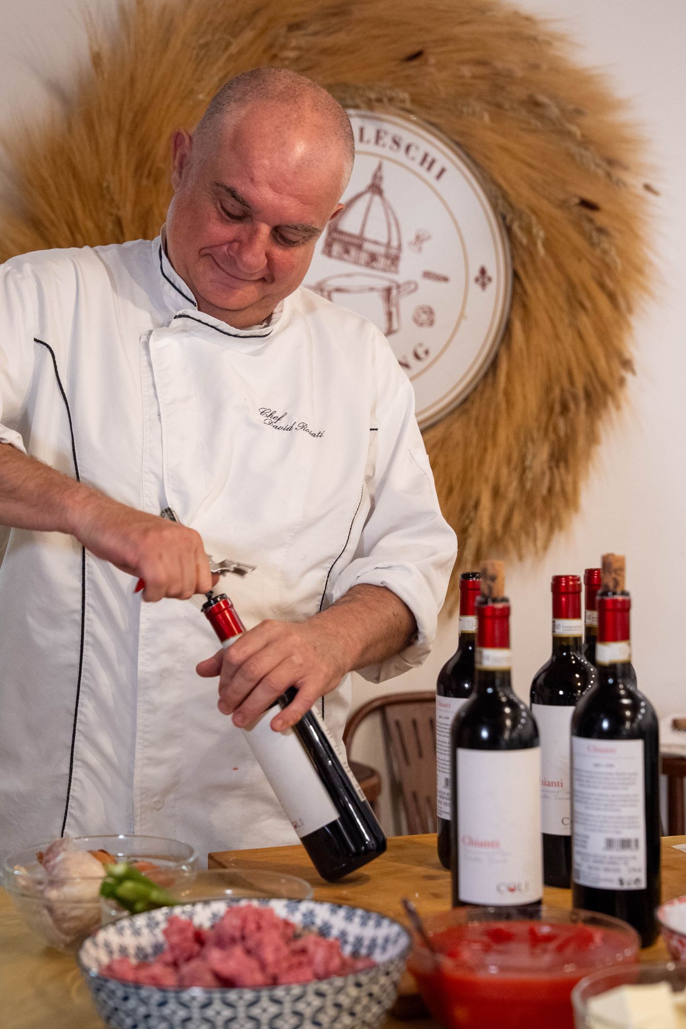 Chef David Rosati opening a bottle of Chianti wine